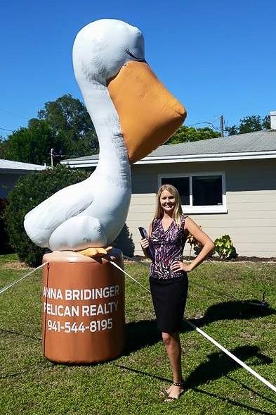 realtor standing next to Custom Inflatable Pelican