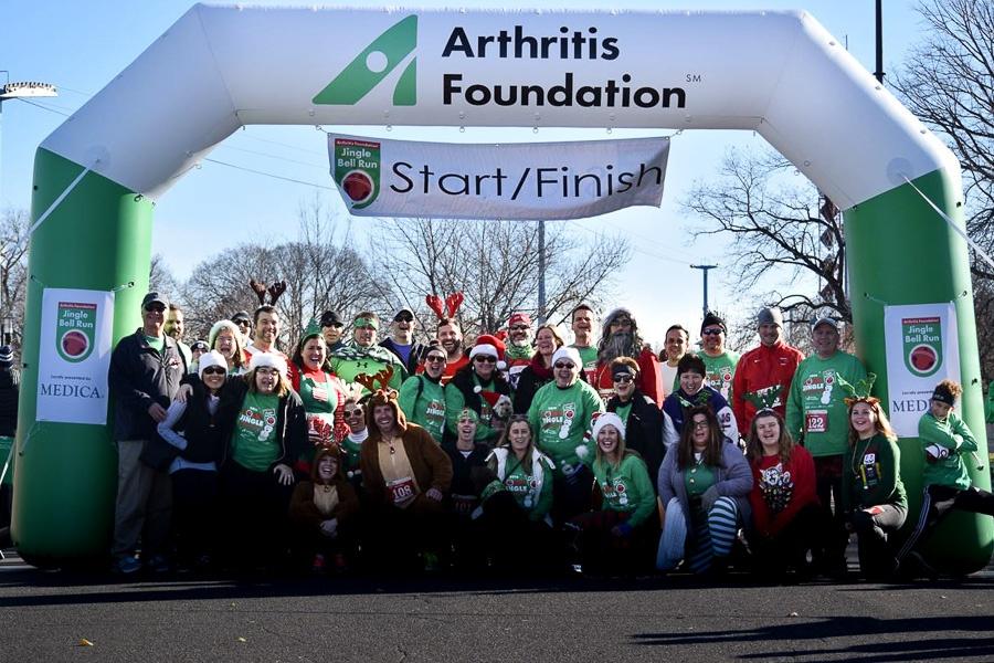 Holiday Group in front of Arthritis Foundation's Custom Inflatable Arch