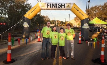 Group posing in front of Custom Inflatable SISU Arch