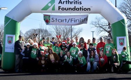 Holiday Group in front of Arthritis Foundation's Custom Inflatable Arch